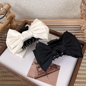Large elegant satin bow hair claw clips in black and cream for women's hair styling