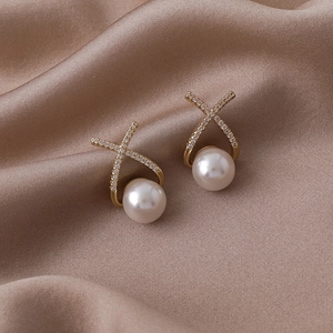 Boucles d'oreilles perles dorées avec design croisé en cristal sur soie champagne