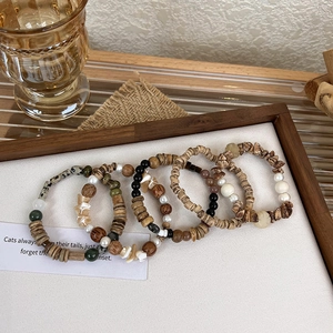 Macro view of bohemian multi-strand bracelets with wood beads, pearls and stones