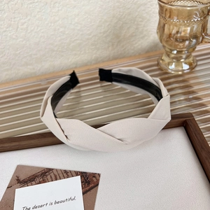 Detail of twisted cream fabric headband on wooden frame with French vintage style