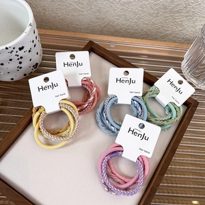 Five-pack of candy-colored braided elastic hair bands displayed in a wooden tray