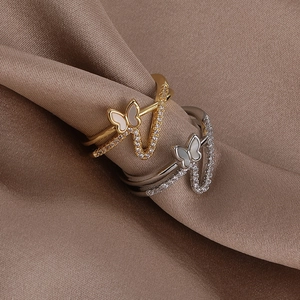 Elegant gold and silver butterfly rings with shell inlay and cubic zirconia on silk