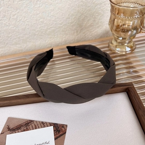 Detail showing the dark brown braided headband with high-quality twill fabric texture