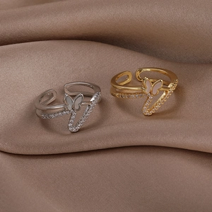 Detailed macro shot of silver and gold butterfly rings with shimmering zircon accents