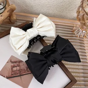 Elegant large double-layered bow hair claws in satin black and cream white for women