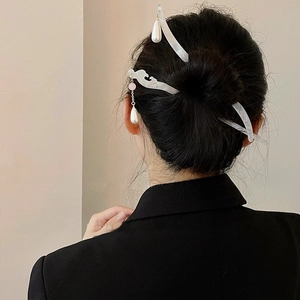 Elegant Chinese style acetate hair stick with pearl tassel on a minimalist bun hairstyle