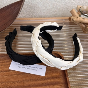 Detail of French vintage satin braided headbands in black and cream with silk texture