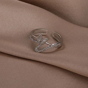 Close-up of adjustable butterfly ring with shell texture and shimmering zircon stones