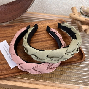 Close-up of vintage braided satin headband in dusty pink and olive green tones