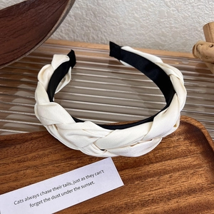 Detail of French vintage braided headband featuring ivory satin fabric and non-slip lining