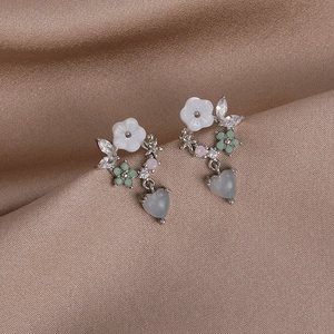 Detail of S925 silver flower earrings with colorful zircon and heart-shaped green stone