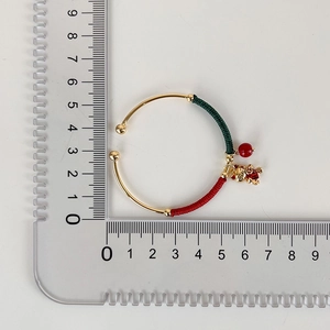 Detailed view of Chinese style cat charm bracelet with red thread showing its precise size