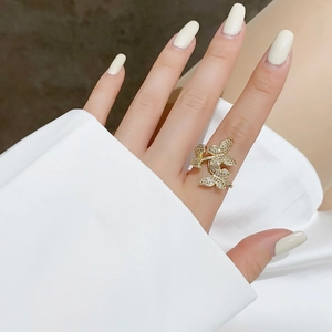 Detailed view of the sparkling butterfly ring with white zircon stones on model hand