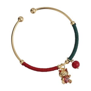 Chinese style gold bracelet with lucky cat charm and red nylon woven thread