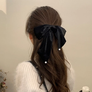Elegant French style black velvet hair bow with pearl accents on long hair for women