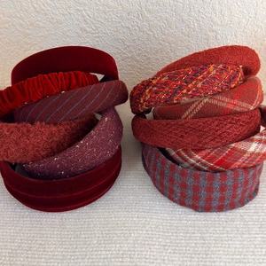 Close-up detail of burgundy velvet and plaid headbands with varied fabric textures