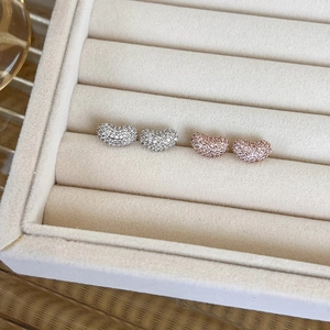 Luxurious bean-shaped stud earrings in rose gold and silver with micro-paved cubic zirconia