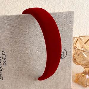 Detail of vintage burgundy plush velvet padded headband with elegant thick texture