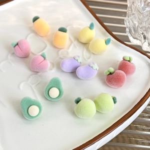 Close-up of various colorful flocked fruit charms for DIY jewelry and accessories