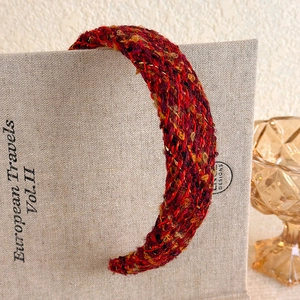 Detail of vintage burgundy tweed headband with woven texture and high crown design