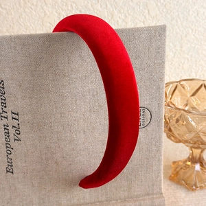Macro shot of thick burgundy velvet headband highlighting soft texture and plush design