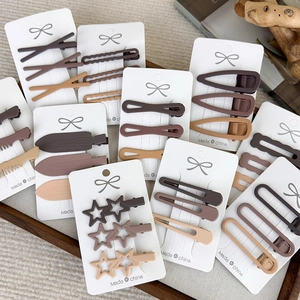 Set of minimalist matte brown hair clips in various shapes like stars and rectangles