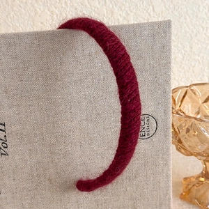 Detailed close-up of retro burgundy plush knit headband with soft mohair texture