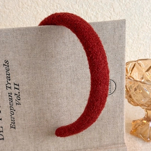 Close-up of vintage burgundy plush headband with textured faux wool fabric for winter