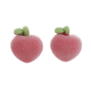Close-up of sweet flocked peach earrings with realistic texture and green leaves