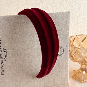 Macro shot of the burgundy velvet headband texture with a plush high-top design