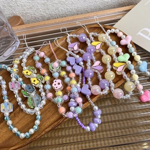 Detailed view of colorful macaron beaded phone straps with heart and flower acrylic charms