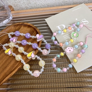 Detailed close-up of handmade beaded phone straps with colorful hearts and cat paw charms