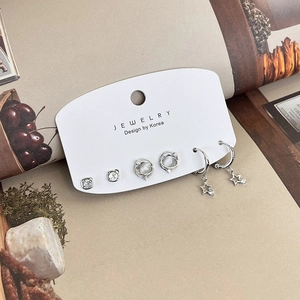 6-piece set of silver earrings with star, planet, and zircon designs on a display card
