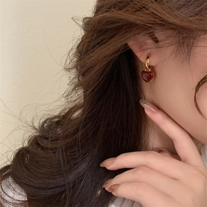 French retro heart drop earrings with gold hoops and red enamel charms on model