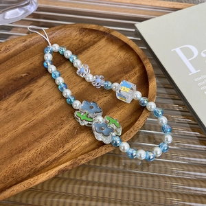 Detailed close-up of handmade ins style beaded phone strap with blue aurora beads and charms