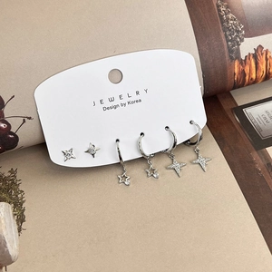 Detail of 6-piece silver star earring set with zircon studs and star charms on jewelry card