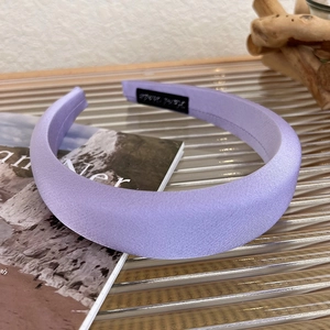 Detailed side view of the lavender satin padded headband with high gloss fabric texture