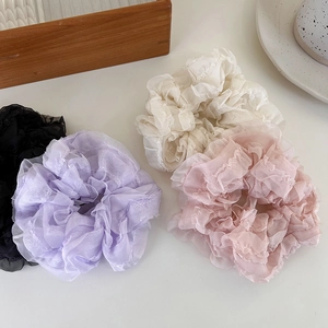 Set of mesh scrunchies in black, purple, white, and pink with ruffle edge design