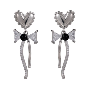 Elegant silver bow earrings with heart studs, black beads, and shimmering zircons