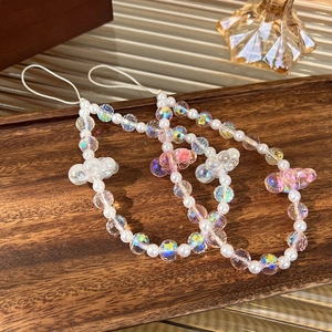 Detailed macro view of colorful crystal pearls and cloud-shaped beads for mobile phone charms