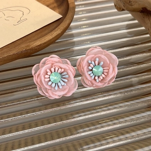 Detail of pink mesh tulle flower earrings with light green crystal center
