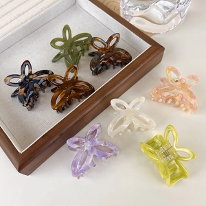 Hollow butterfly hair claws in various acetate colors including floral blue and lilac
