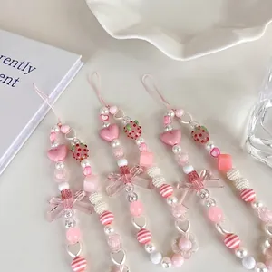Pink and white handmade strawberry beaded phone lanyard with cute charms for women