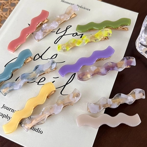 Set of wavy acetate hair clips in various colors and marble patterns for women