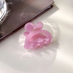 Détail du petit clip à cheveux en acétate rose avec inscription dorée France