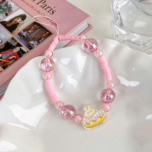 Detailed shot of pink beaded phone charm with cartoon rabbit cake acrylic pendant