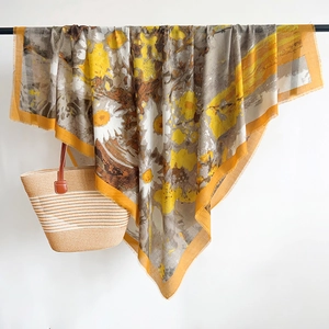 Detail of yellow daisy print cotton linen scarf hanging naturally with fringed edges