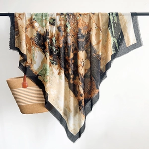 Detail of artistic cotton linen scarf with abstract print and delicate fringe tassels