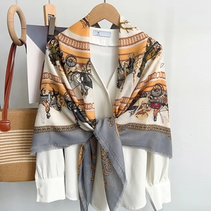 Detail of elegant horse carriage print scarf tied over a white high-neck silk shirt