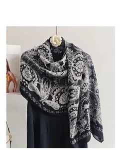 Detailed view of the black and white paisley pattern on this soft cotton-linen feel scarf